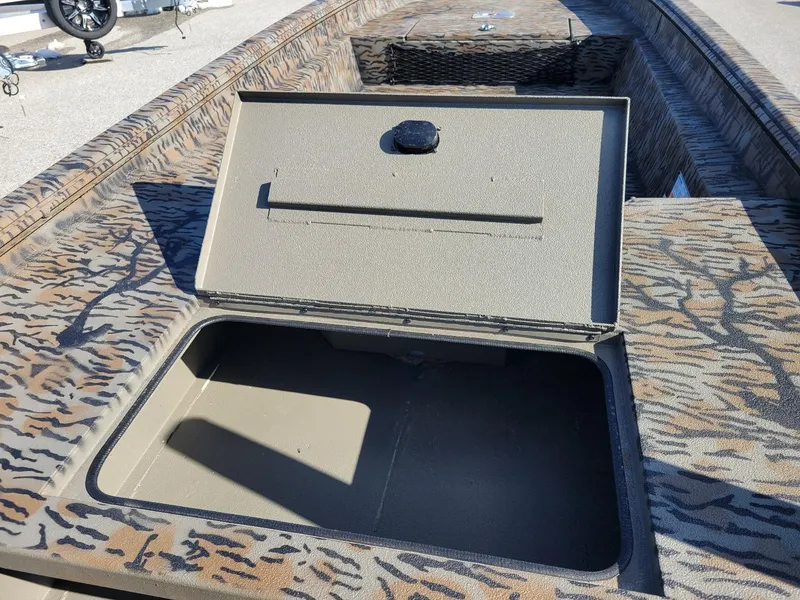 Slide: The Image of 2024 Xpress HD15DBX duck hunting boat with open storage compartment, camouflage design. - 10