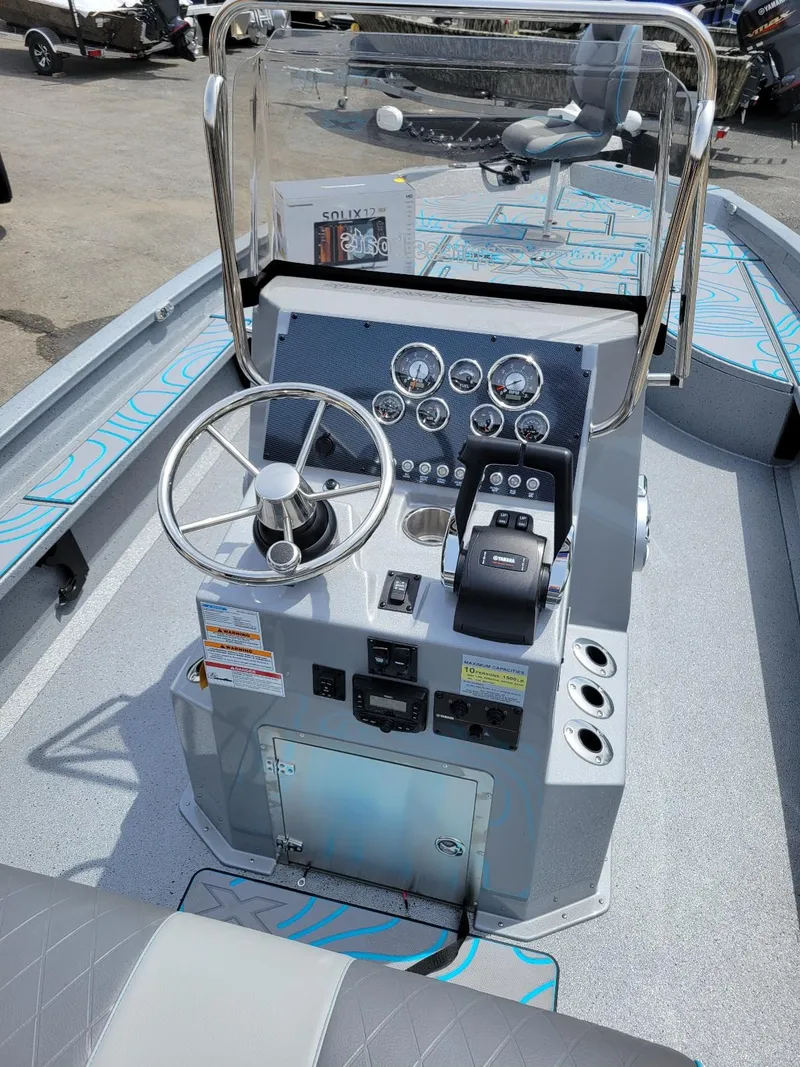 Slide: The Image of 2024 Xpress X23 Bay Lounge with dual Yamaha 150 engines, featuring a modern console. - 12
