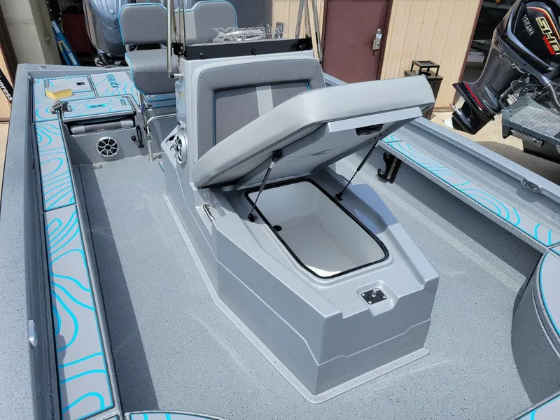 Slide: The Image of 2024 Xpress X23 Bay Lounge boat with dual Yamaha 150 engines, featuring open storage compartment. - 15