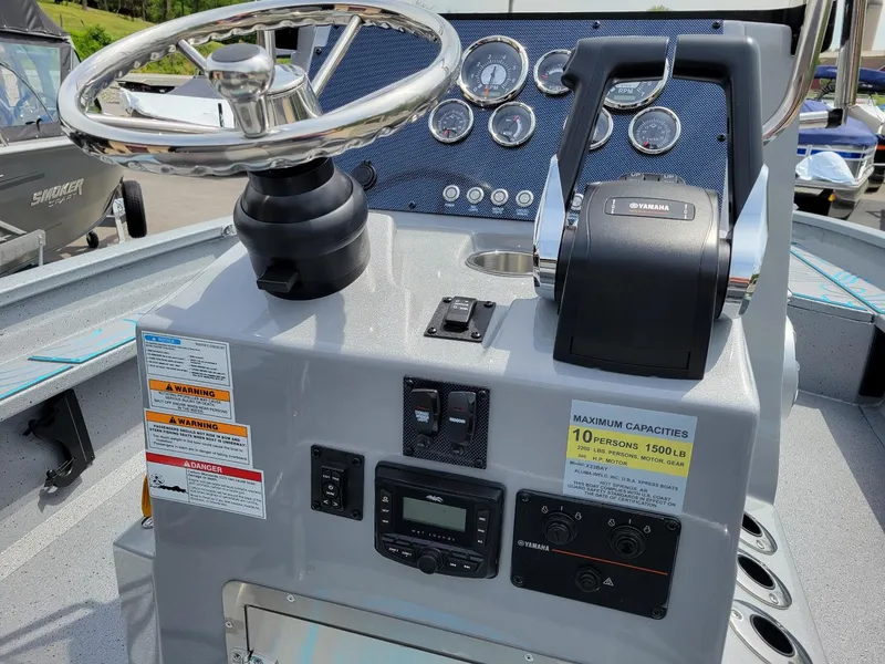 Slide: The Image of 2024 Xpress X23 Bay Lounge with dual Yamaha 150 engines, steering console and controls. - 16