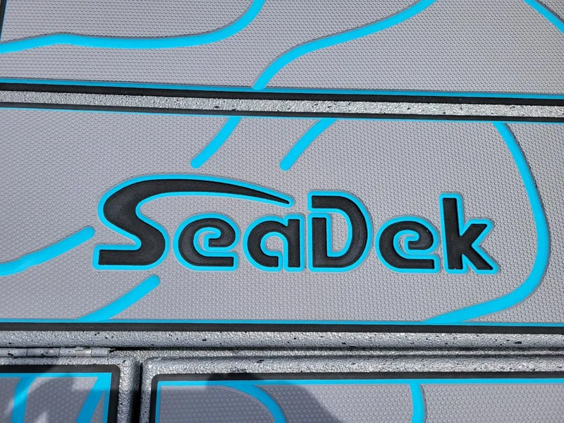 Slide: The Image of SeaDek logo on the deck of a 2024 Xpress X23 Bay Lounge boat. - 20