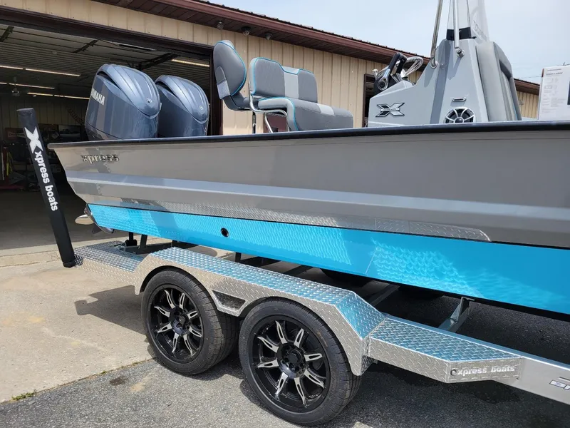 Slide: The Image of 2024 Xpress X23 Bay Lounge boat with dual Yamaha 150 engines on trailer. - 4