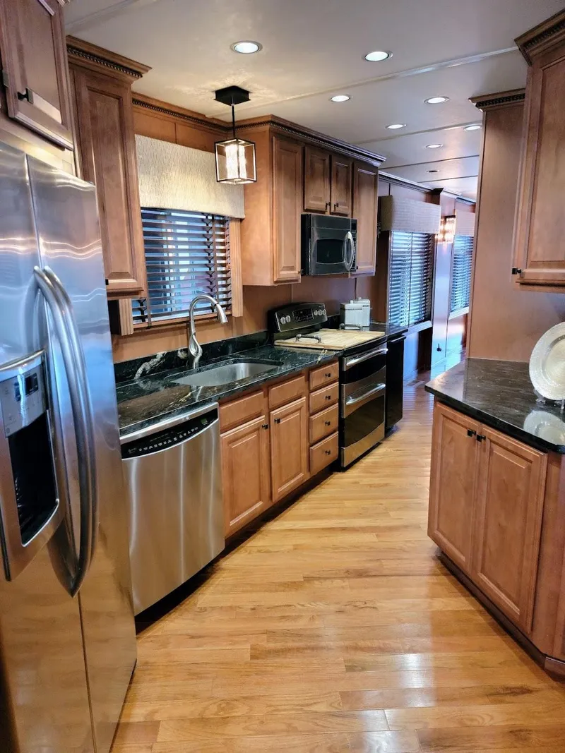 Slide: The Image of Modern kitchen interior on a 2008 Sumerset Houseboat with stainless steel appliances. - 11