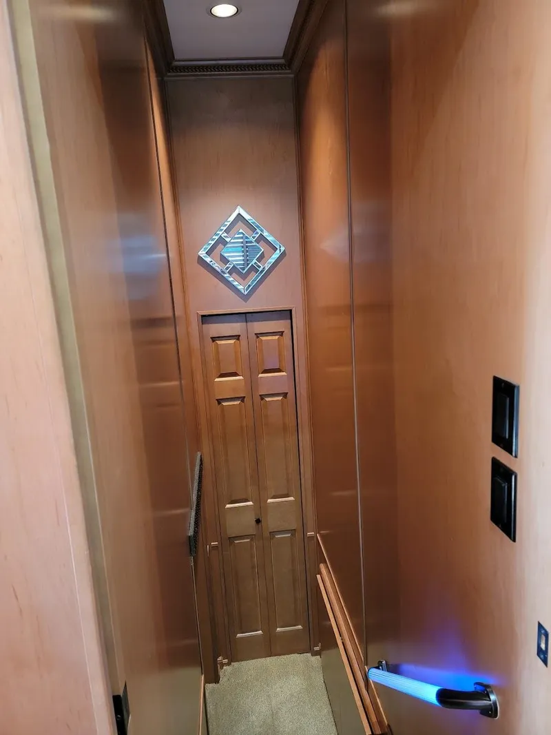 Slide: The Image of 2008 Sumerset Houseboat interior hallway with wooden paneling and decorative wall art. - 13