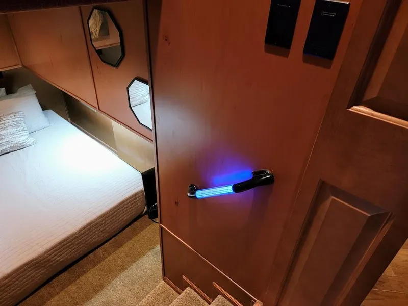 Slide: The Image of 2008 Sumerset Houseboat interior bedroom with illuminated door handle. - 14