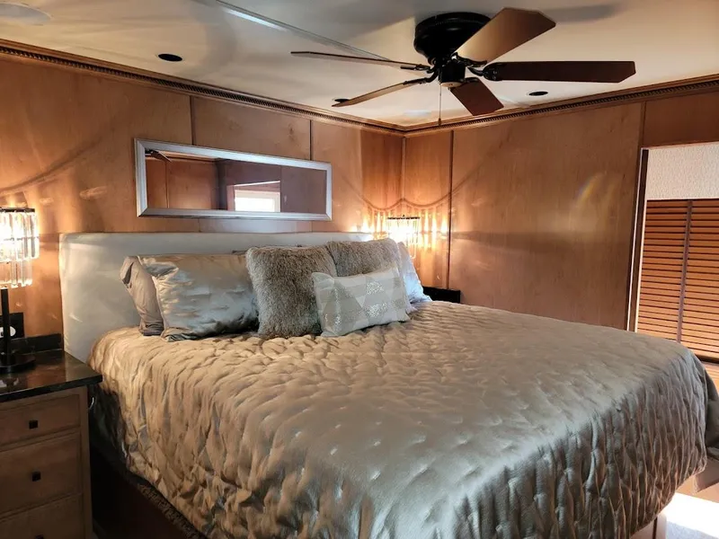 Slide: The Image of Luxurious bedroom in a 2008 Sumerset Houseboat with elegant bedding and modern decor. - 16
