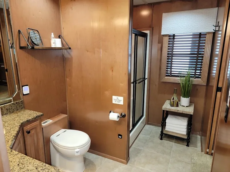 Slide: The Image of Modern bathroom in a 2008 Sumerset Houseboat with granite countertops and a glass shower. - 18