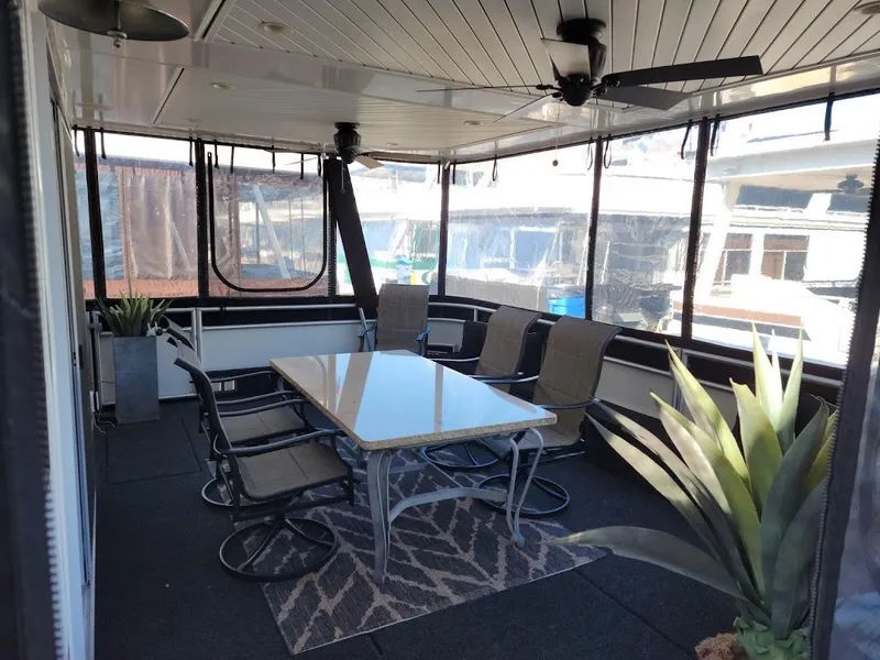 Slide: The Image of 2008 Sumerset Houseboat interior with dining area and large windows. - 2