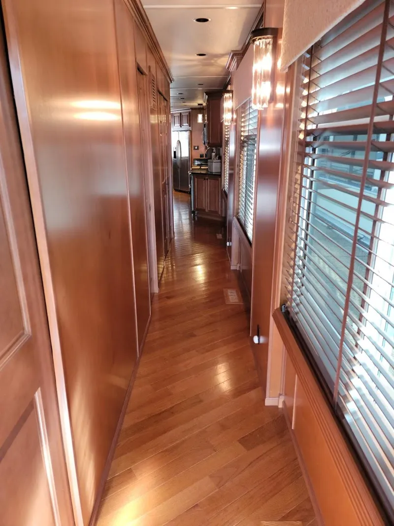 Slide: The Image of 2008 Sumerset Houseboat interior hallway with wooden flooring and large windows. - 21