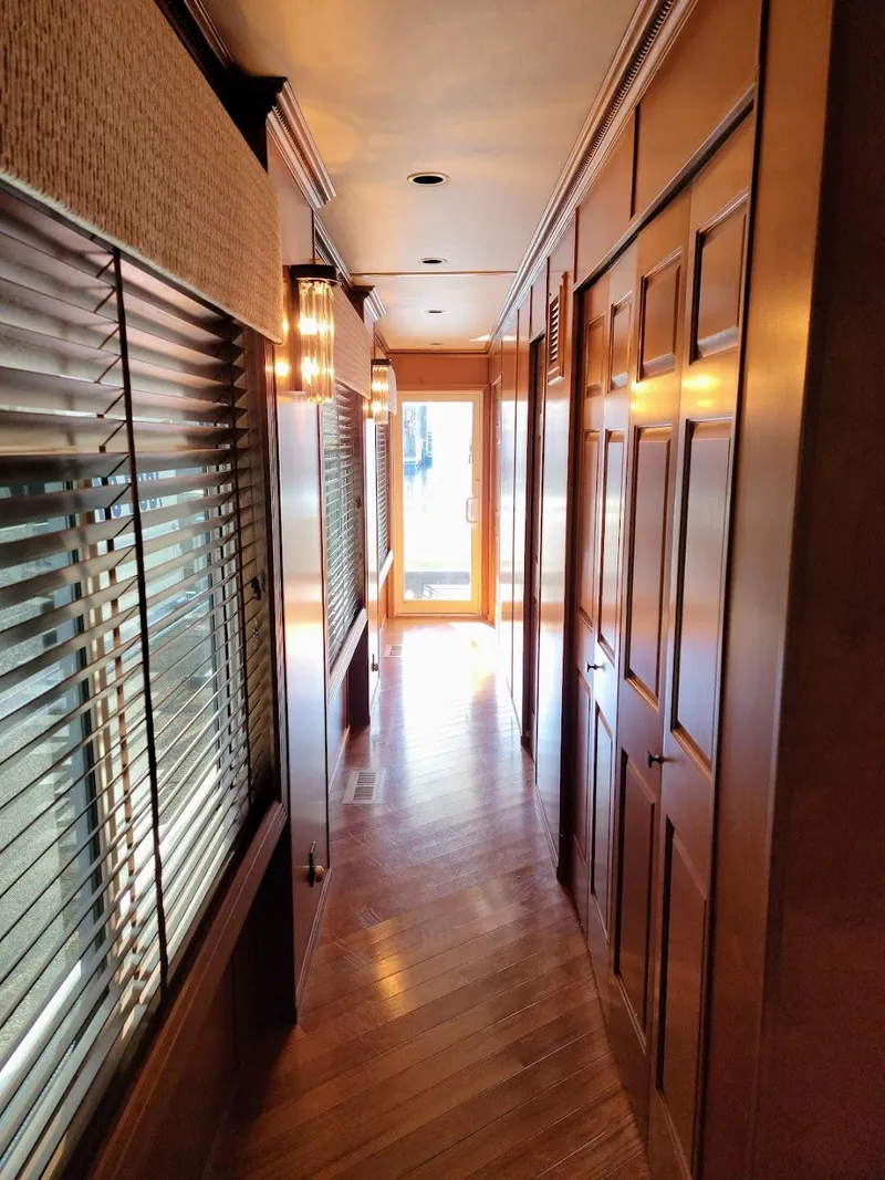 Slide: The Image of Interior hallway of a 2008 Sumerset Houseboat with wooden paneling and blinds. - 22