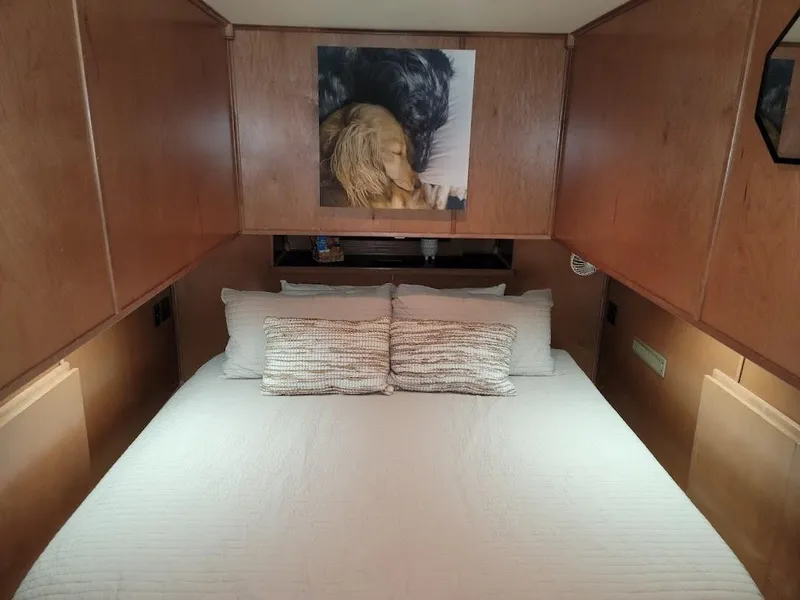 Slide: The Image of Sumerset 2008 houseboat bedroom with wooden cabinets and a cozy bed. - 25