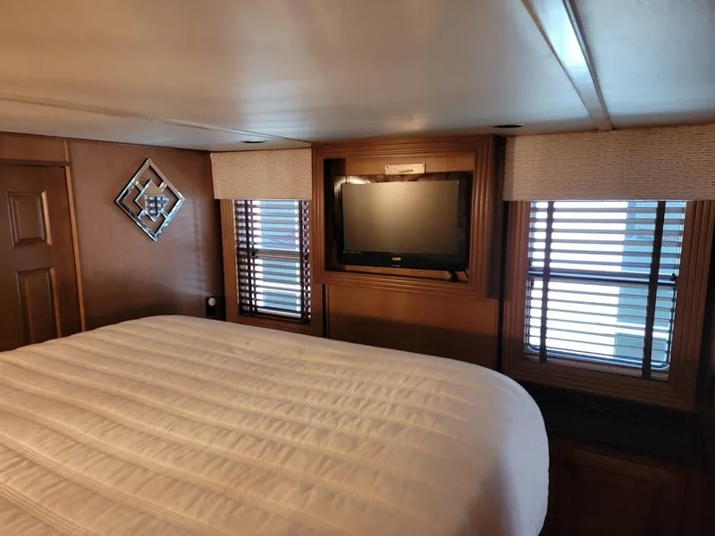 Slide: The Image of 2008 Sumerset Houseboat bedroom with TV, windows, and bed. - 26