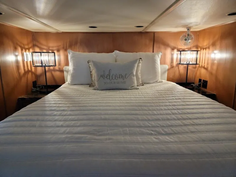 Slide: The Image of Cozy bedroom in a 2008 Sumerset Houseboat with a welcoming pillow and ambient lighting. - 27