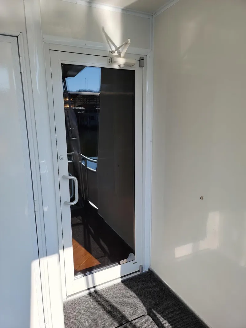Slide: The Image of 2008 Sumerset Houseboat entrance with glass door and white frame. - 39