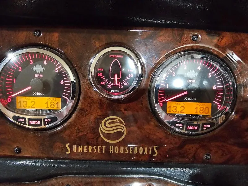 Slide: The Image of Dashboard of a 2008 Sumerset Houseboat with RPM and steering gauges. - 4