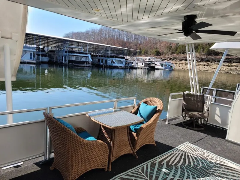 Slide: The Image of 2008 Sumerset Houseboat with outdoor seating area, docked at a marina. - 42