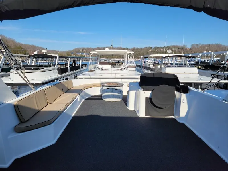 Slide: The Image of 2008 Sumerset Houseboat with spacious deck and seating at marina. - 47