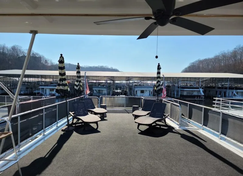 Slide: The Image of Top deck of a 2008 Sumerset Houseboat with lounge chairs and umbrellas. - 49