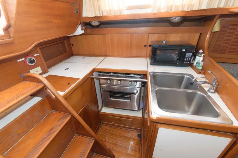 Slide: The Image of 1984 Sabre 38 MK I yacht kitchen with stove, sink, and microwave. - 10