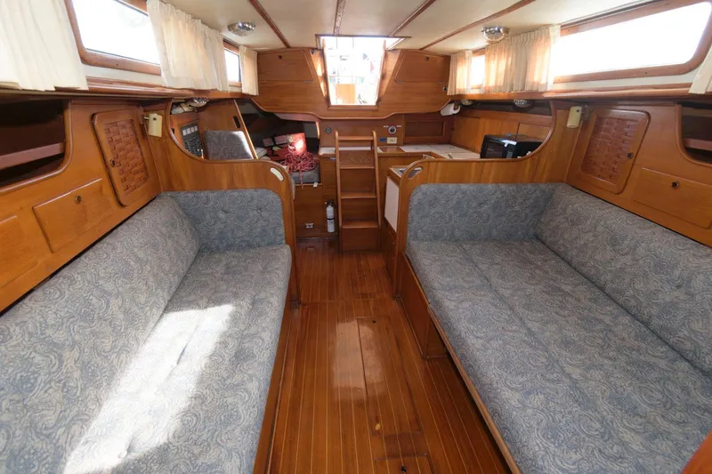 Slide: The Image of Interior of 1984 Sabre 38 MK I sailboat with wooden finish and blue upholstered seating. - 12