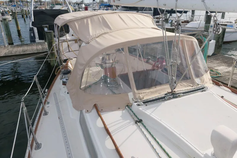Slide: The Image of 1984 Sabre 38 MK I sailboat docked at a marina with beige canvas cover. - 2