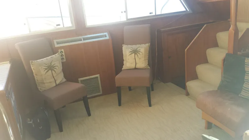 Slide: The Image of Interior of a 1975 Uniflite Aft Cabin with chairs and cushions. - 10