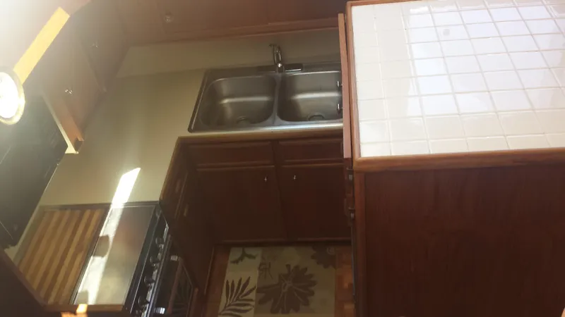 Slide: The Image of 1975 Uniflite Aft Cabin yacht interior with sink and countertop. - 11