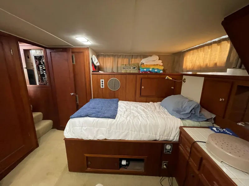 Slide: The Image of Interior of a 1975 Uniflite Aft Cabin with cozy bed and wooden furnishings. - 15