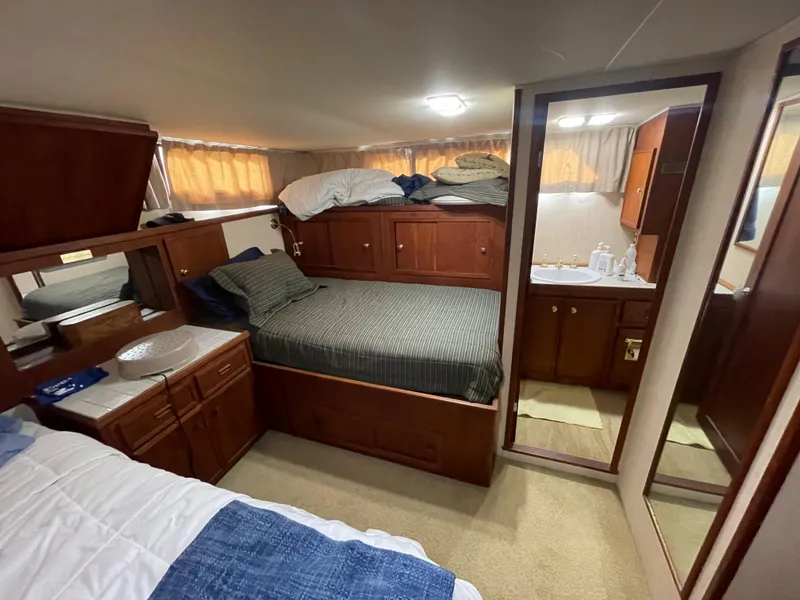 Slide: The Image of Interior of a 1975 Uniflite Aft Cabin with double bed and mirror. - 19