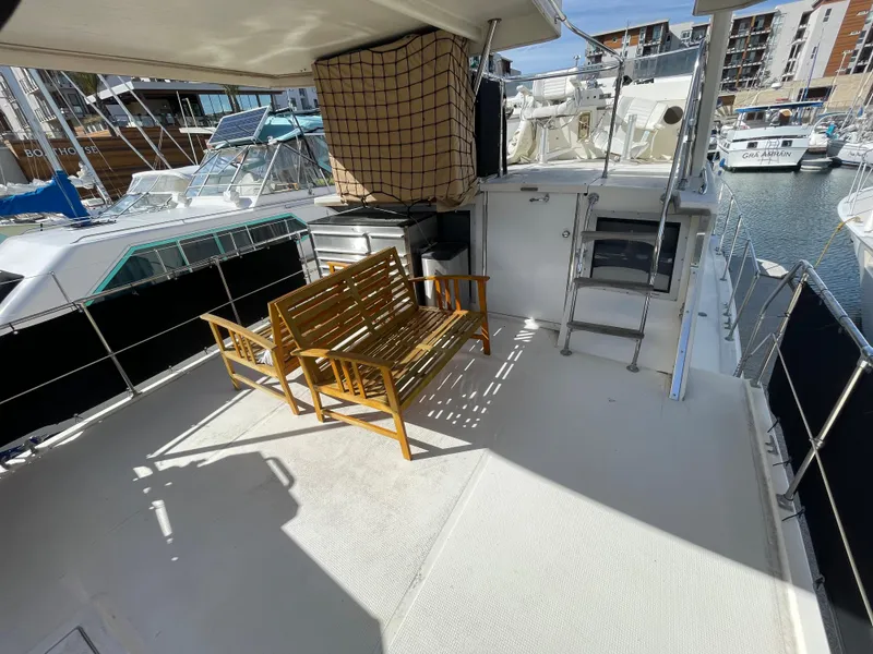 Slide: The Image of 1975 Uniflite Aft Cabin with wooden benches in marina. - 28