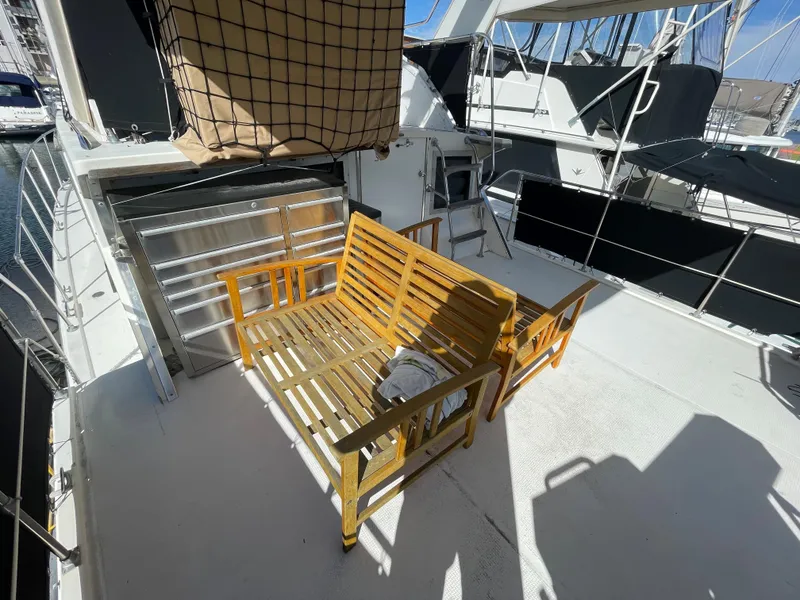Slide: The Image of 1975 Uniflite Aft Cabin with wooden benches on deck. - 29