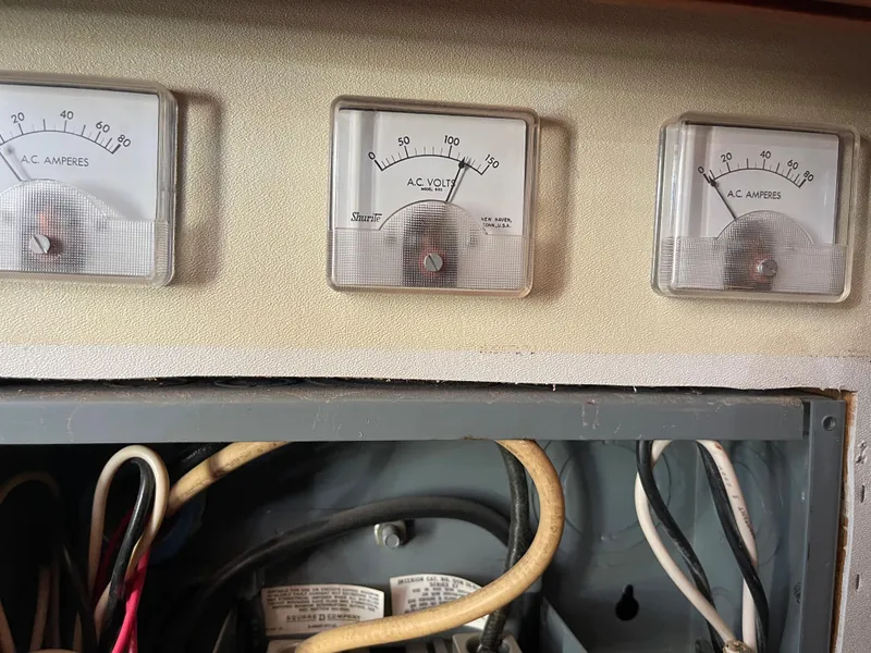 Slide: The Image of 1975 Uniflite Aft Cabin boat dashboard with gauges. - 31