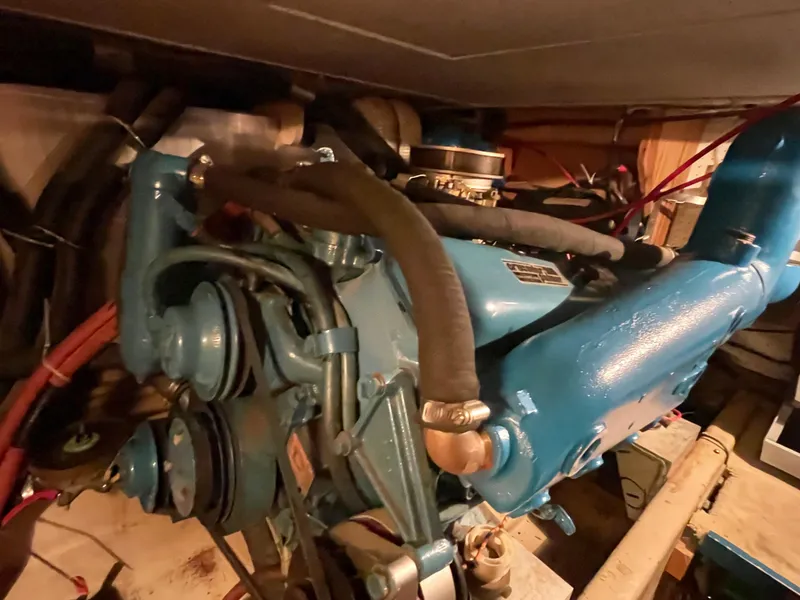Slide: The Image of Engine room of a 1975 Uniflite Aft Cabin boat, featuring blue engine. - 36
