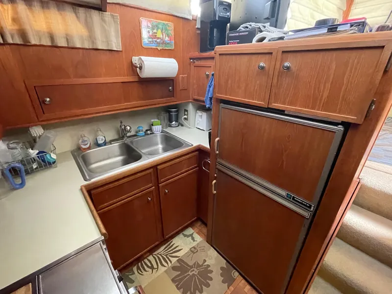 Slide: The Image of 1975 Uniflite Aft Cabin yacht kitchen with wooden cabinets. - 41