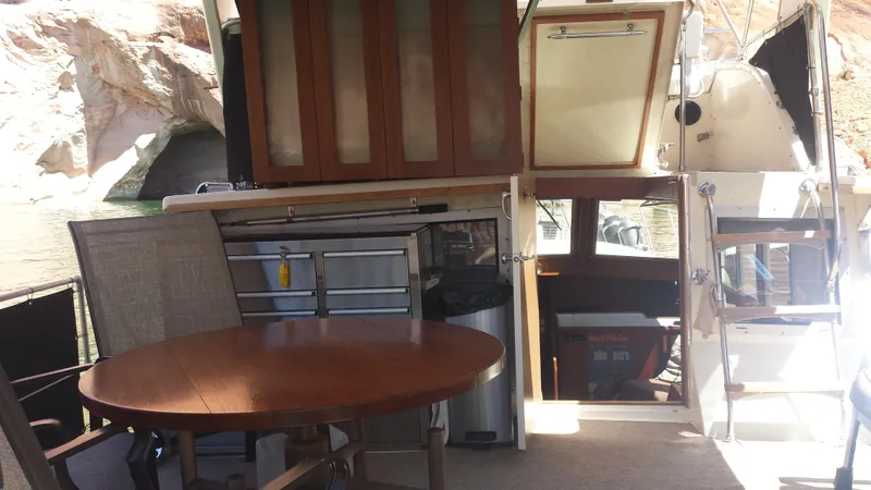 Slide: The Image of Interior of a 1975 Uniflite Aft Cabin yacht with table and chairs. - 8