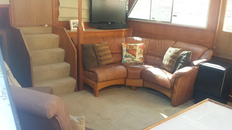 Slide: The Image of Interior of a 1975 Uniflite Aft Cabin with leather sofa and TV. - 9
