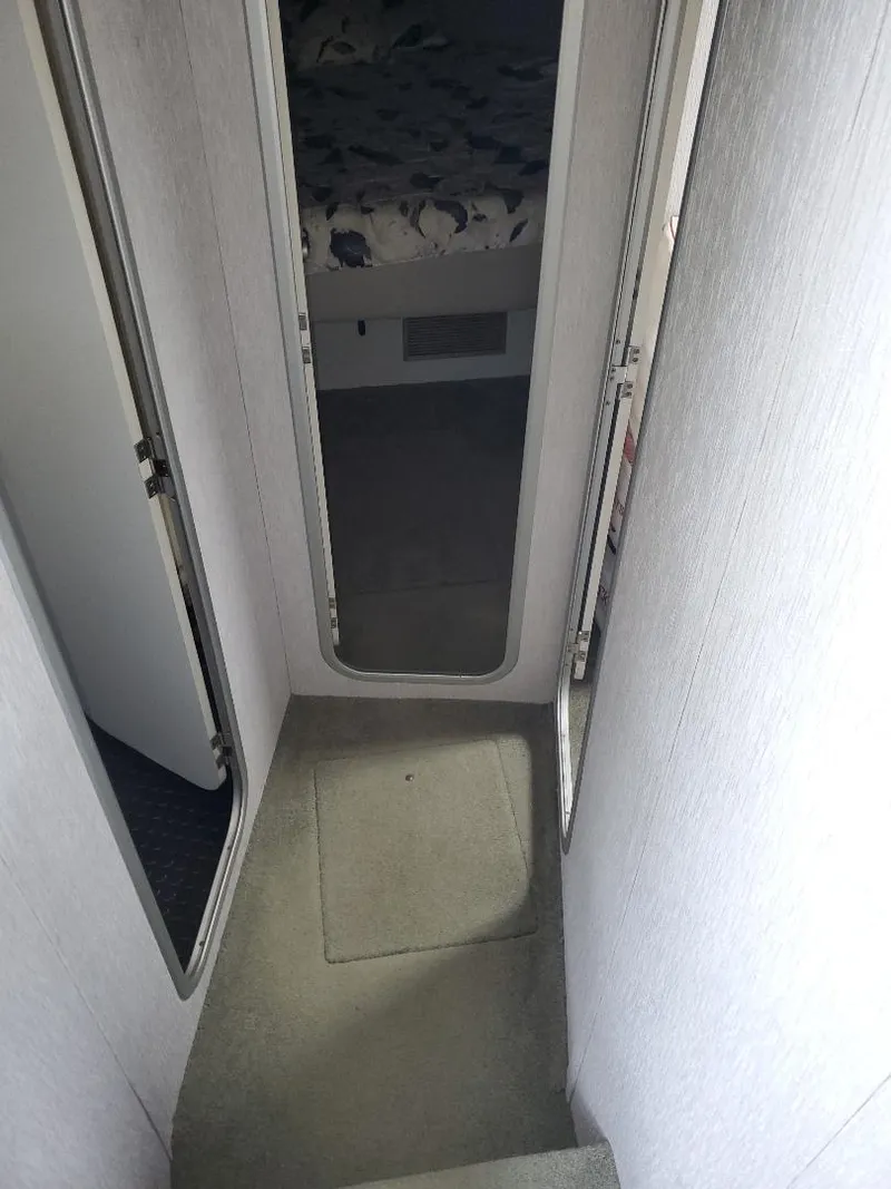 Slide: The Image of 1990 Mainship Mediterranean interior hallway with carpeted steps and mirrored door. - 16