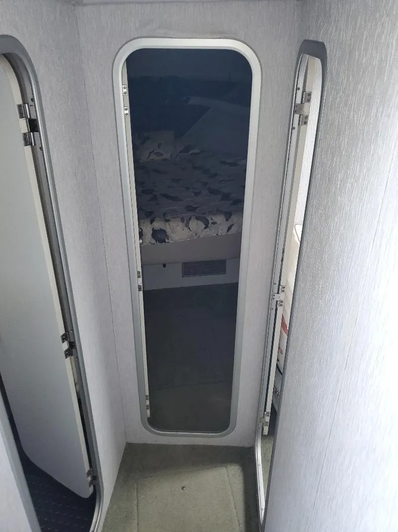 Slide: The Image of 1990 Mainship Mediteranian interior hallway with mirrored doors and visible bedroom. - 20