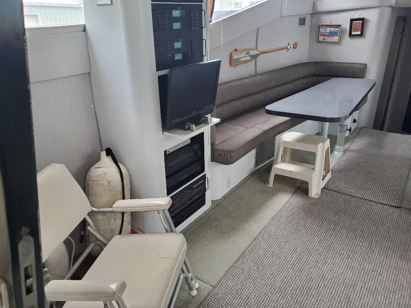 Slide: The Image of 1990 Mainship Mediterranean yacht interior with seating, table, and electronics. - 9