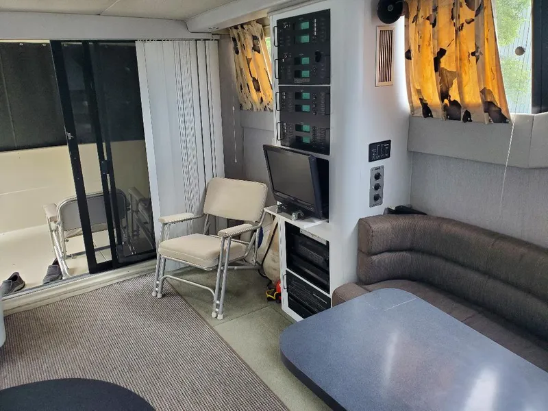 Slide: The Image of Interior of a 1990 Mainship Mediterranean yacht with seating, table, and control panels. - 10