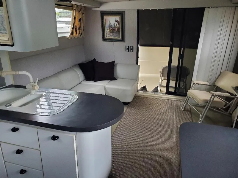 Slide: The Image of 1990 Mainship Mediterranean yacht interior with modern kitchen, cozy seating, and elegant decor. - 15