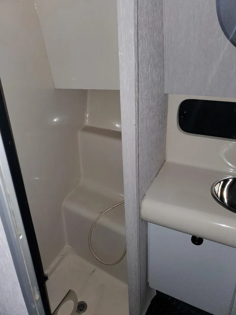 Slide: The Image of 1990 Mainship Mediterranean boat bathroom with shower and sink. - 19