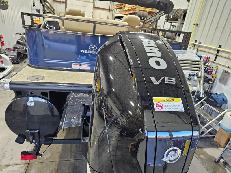 Slide: The Image of 2024 Regency 250 DL3 boat with powerful V8 outboard motor in a workshop. - 3