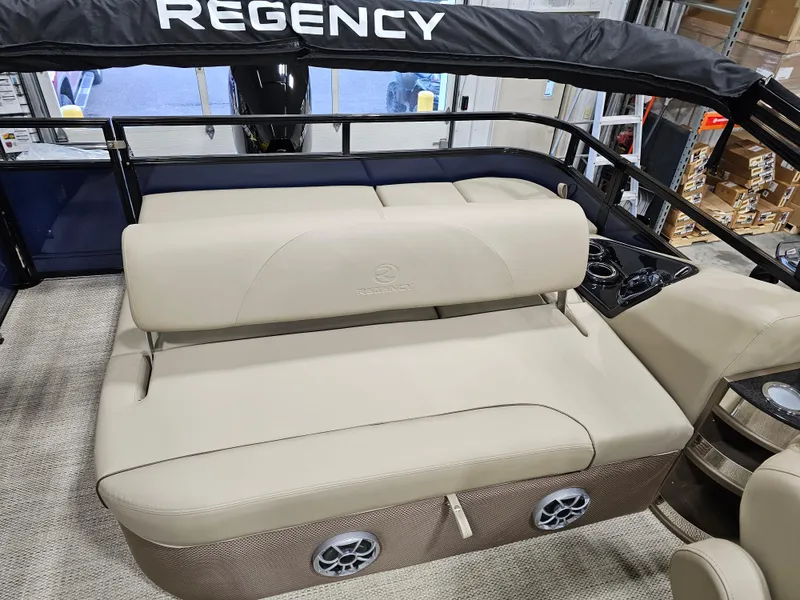 Slide: The Image of 2024 Regency 250 DL3 boat interior with beige seating and black railing. - 7