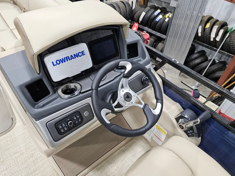 Slide: The Image of 2024 Regency 250 DL3 boat dashboard with Lowrance display and steering wheel. - 9