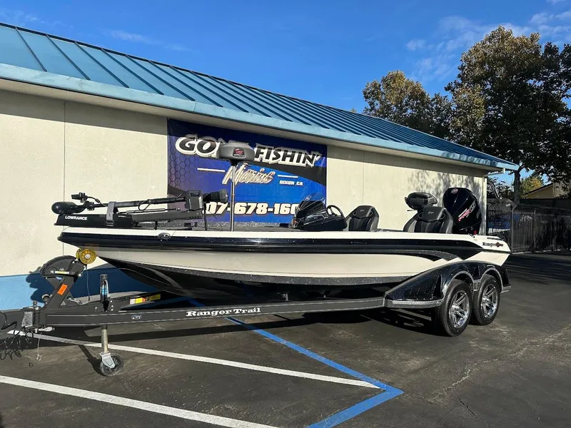Slide: The Image of 2024 Ranger Z520R fishing boat on trailer outside a store. - 1