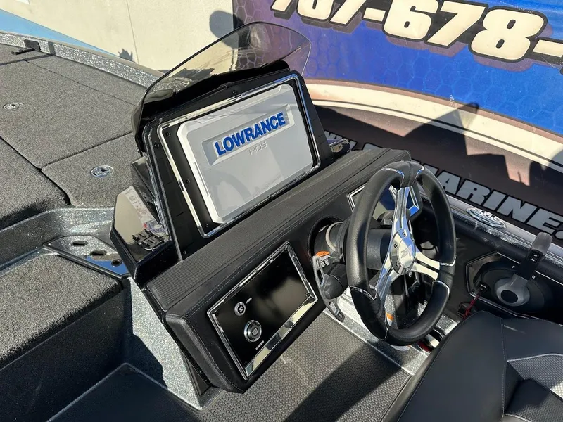Slide: The Image of 2024 Ranger Z520R boat dashboard with Lowrance display and steering wheel. - 13