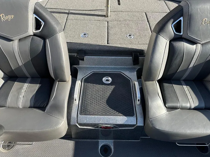 Slide: The Image of 2024 Ranger Z520R boat interior with dual seats and storage compartment. - 18
