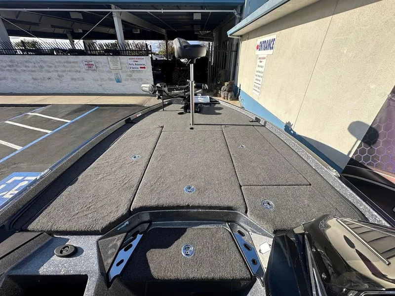 Slide: The Image of 2024 Ranger Z520R boat deck with storage compartments and fishing equipment. - 20