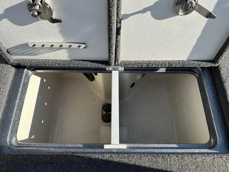 Slide: The Image of 2024 Ranger Z520R storage compartment with open hatch and secure latches. - 26